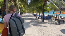 Koh Rong island, Cambodia. Walking on the main beach road, turquoise water and sand beach.