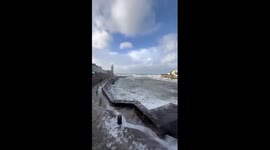 Massive waves hit Porthleven harbor during Storm Chandra in Cornwall, UK