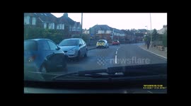 Car on wrong side of road narrowly avoids head-on collision