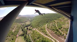 Man BASE jumps from underside of bridge