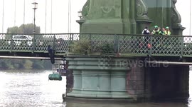Man hanging from Hammersmith Bridge
