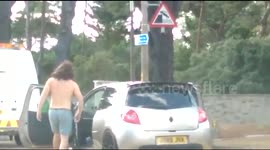 Shirtless man gets out of car to entertain drivers stuck in traffic jam