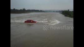 Newsflare Edit - Car trying to cross river gets stuck