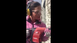 Girl needle gunning the old stone walls by hand wearing pink! #loowithaview cornwall