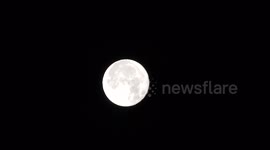Perigee full moon or Supermoon slowly descending in clear skies above Braemar Scotland