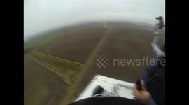 Daredevil base jumps off 200 ft wind turbine