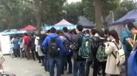Students queue to collect items after online shopping frenzy