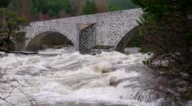 Flood waters following Storm Frank past the Old Brig O' Dee (bridge over the river Dee) by Balmoral Estate January 2016
