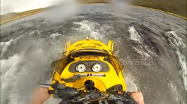 Hydroplaning snowmobile on a river in Iceland