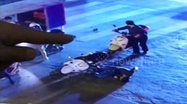 Man waiting for traffic lights on scooter is hit by stone