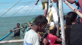 phillipine fisherman casually wraps his gun away