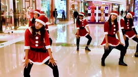 The one hundred girls dressed as Santa Claus dancing