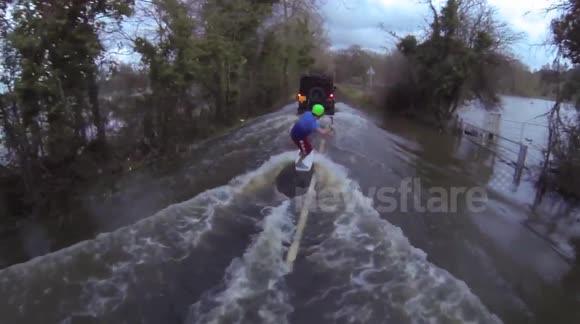 Wakeboarding down a flooded Surrey road