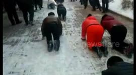 Bakery staff crawl on snow-covered street after failing to hit targets