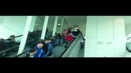 Drunk Man @ Stansted Airport walking up escalator the wrong way