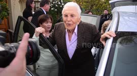 Screen Legend Kirk Douglas gets serenaded by the paparazzi as he leaves home to celebrate his 100 birthday in Beverly Hills, Ca