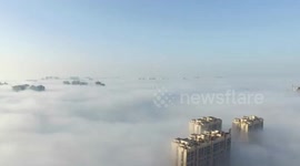 Aerial footage of heavy fog creating sea cloud like fairytale
