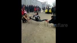 Woman shows off Kung Fu by jump-splitting legs in Langfang,Hebei,China