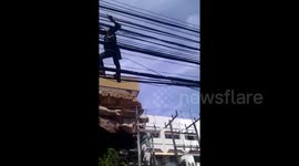 Man walks on electric cables in Thailand
