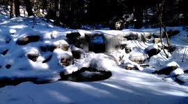 Icy bridge in snow-covered Vermont forest
