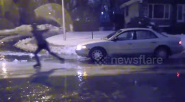 Canadian man ice-skates on frozen road