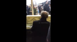 Pianist keeps commuters' spirits up Clapham Junction is evacuated