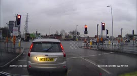 Runs a red light and then drives in to oncoming traffic.