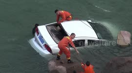 Firefighters and police officers rescue driver who crashed into river