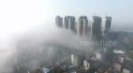 Radiation fog hovers above lake in southern China