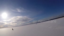 Man goes 'ice kiting' on frozen lake