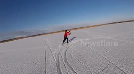 People go ice-kiting on frozen lake Neusiedl