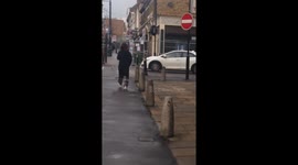 Woman walking around London wearing pyjamas