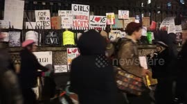 Women's March leave placards at St Martin-in-the-Fields