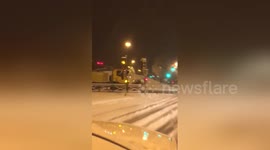 Car overturns while sliding on snowy road