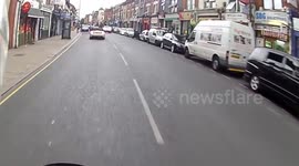 Female driver texting with both hands on her phone in moving traffic London
