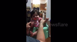 Big hair baby tries baby food for the first time.