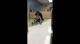 Baby With Down Syndrome walking with a walker