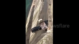 SUV falls off cliff after being hit by out-of-control trailer