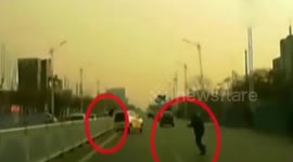 Car drifting on road after avoiding two men