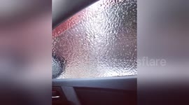 Newsflare Edit - Girl tries to roll down window after freezing rain storm in Ontario, Canada and gets a surprise.